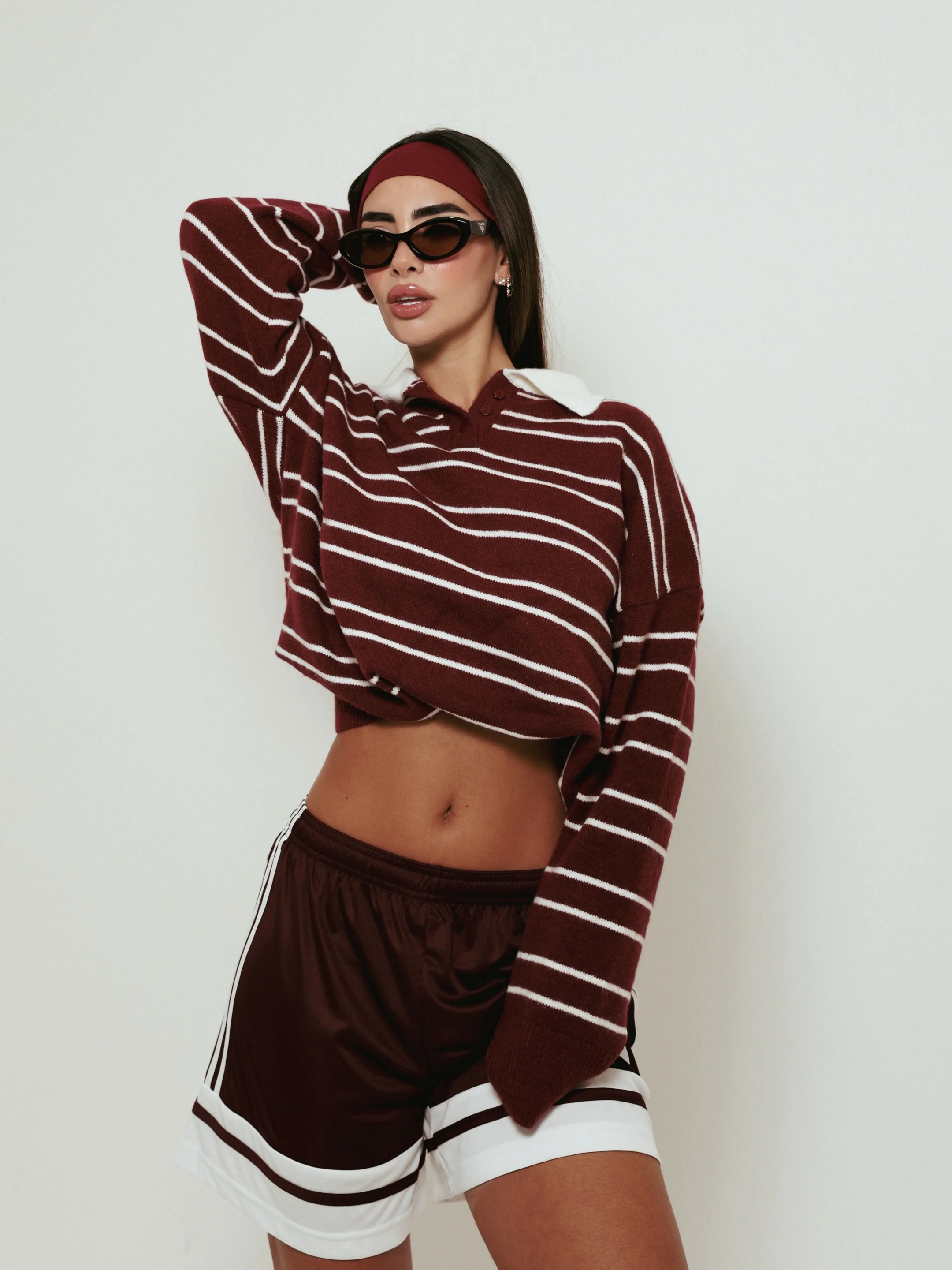 Apparel shoot: striped top, shorts and sunglasses worn on a model in the studio