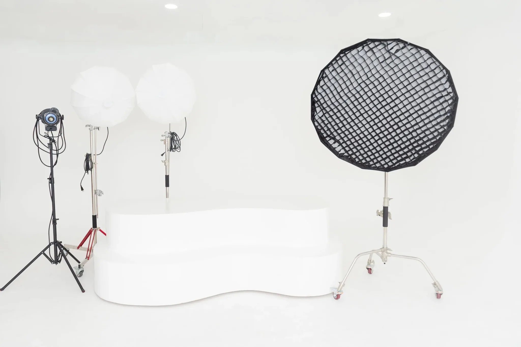 White cyclorama wall with parabolic softbox and fresnel lighting at a Miami photography studio