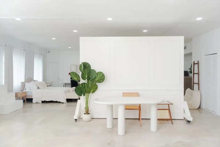 White paneled rolling wall with a pedestal table